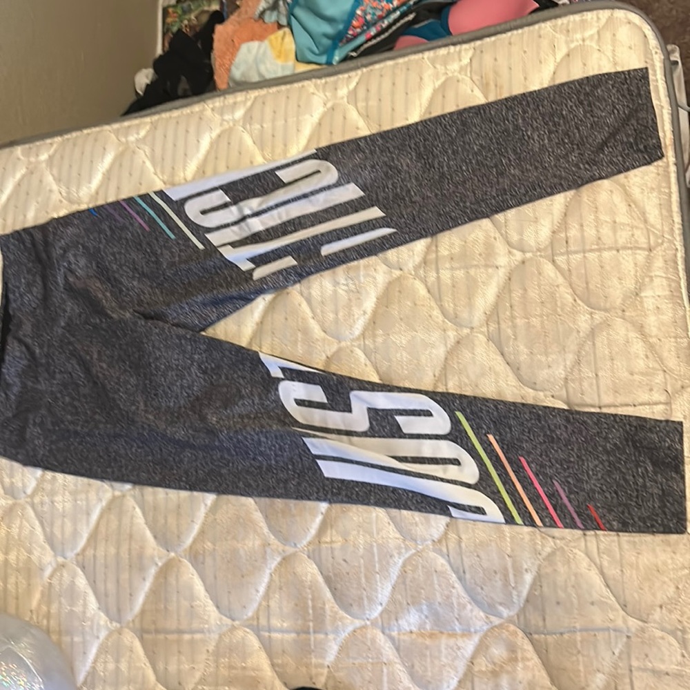 I’m selling grey leggings with the justice sign across them for children